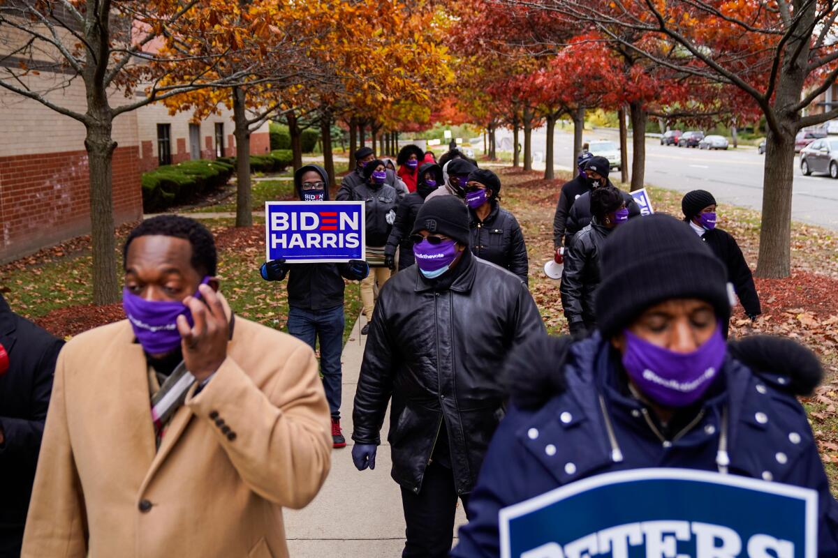 Parishioners walk from Greater Grace Temple toward the Five Points neighborhood in Detroit on Sunday. 