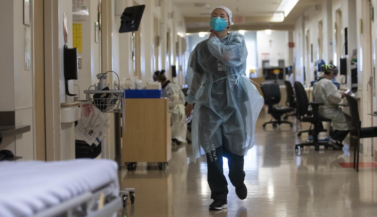 Registered nurse Rebekah Park walks inside Providence Holy Cross Medical Center in Mission Hills on Thursday.