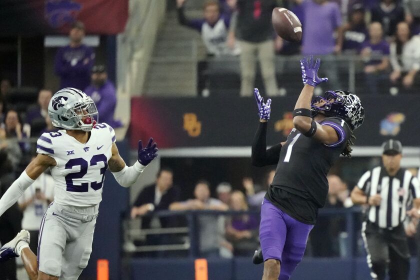 TCU wide receiver Quentin Johnston (1) reaches for a pass in front of Kansas State cornerback Julius Brents (23) in the first half of the Big 12 Conference championship NCAA college football game, Saturday, Dec. 3, 2022, in Arlington, Texas. (AP Photo/LM Otero)
