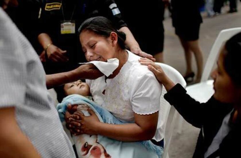 Miriam Ramirez Amador, center, mourns her brother Roberto Amador, an anti-drug agent, during his funeral in Guatemala City on April 25. Roberto Amador was killed along with four other agents in a shootout with alleged drug traffickers.