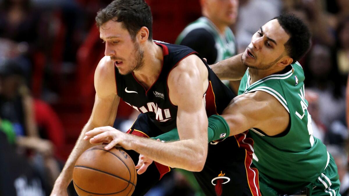 Celtics guard Shane Larkin attempts to steals the ball from Heat guard Goran Dragic during the second half Wednesday.