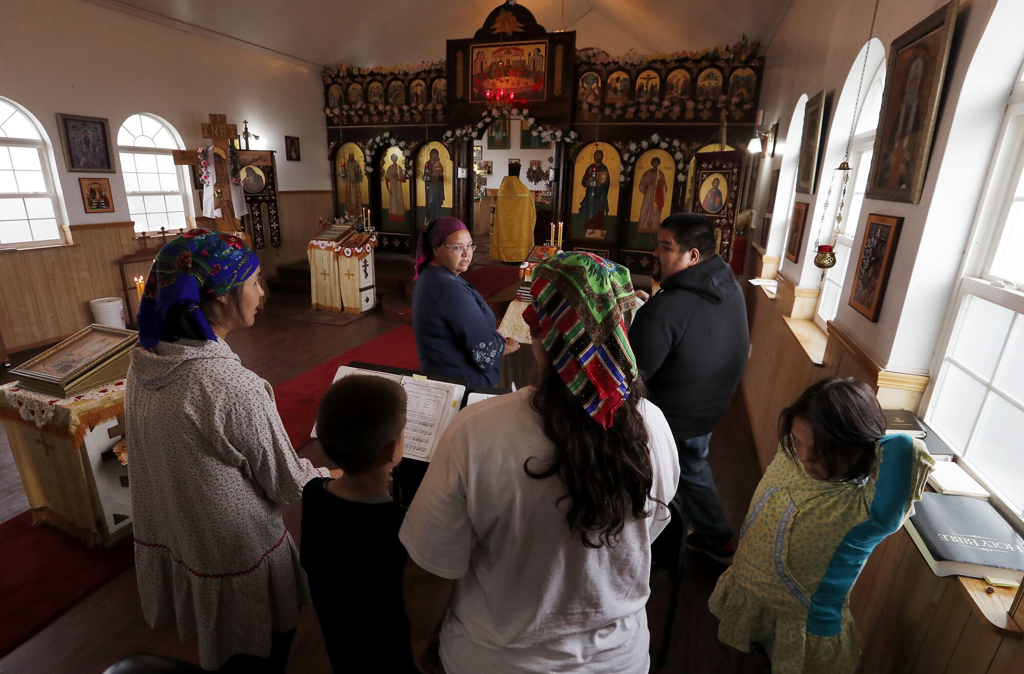 Choir members prepare to sing at the Russian Orthodox Church in Newhalen, Alaska.