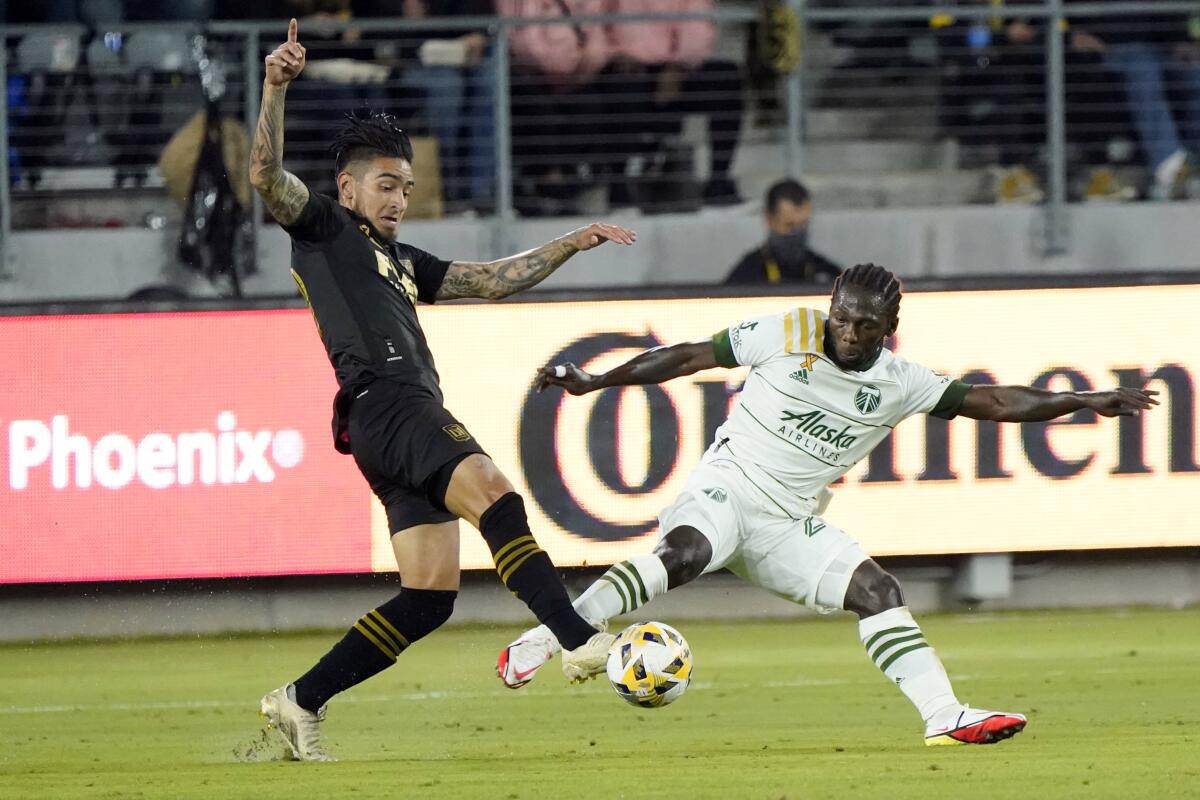LAFC forward Cristian Arango and Portland Timbers forward Yimmi Chara vie for the ball during a match