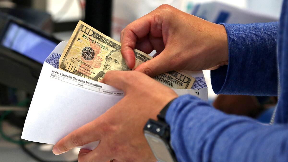 Chay conducts a financial transaction at a Walgreens in Hollywood.