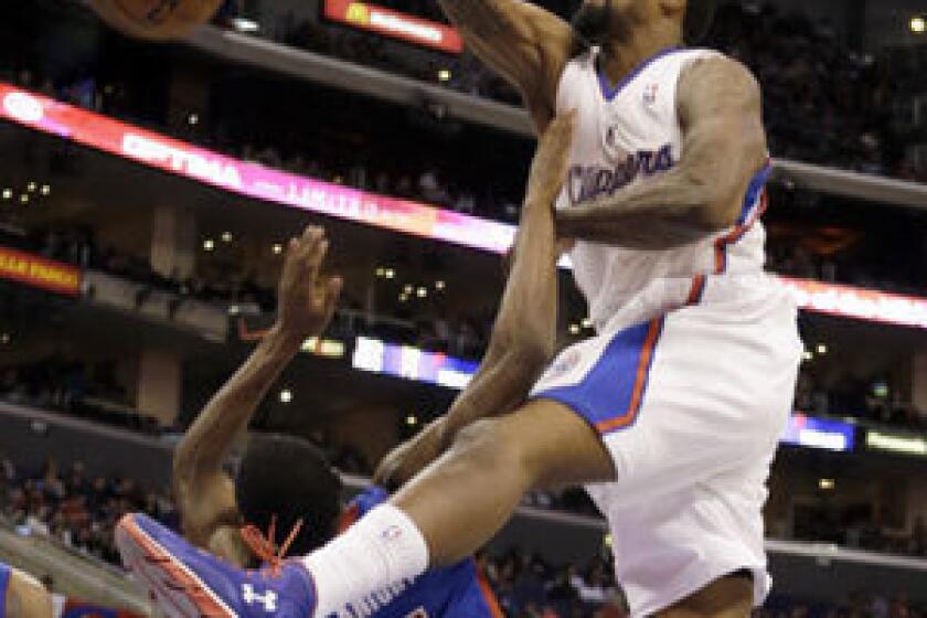 DeAndre Jordan dunks on Detroit's Brandon Knight during the second quarter of the Clippers' 129-97 victory at Staples Center.