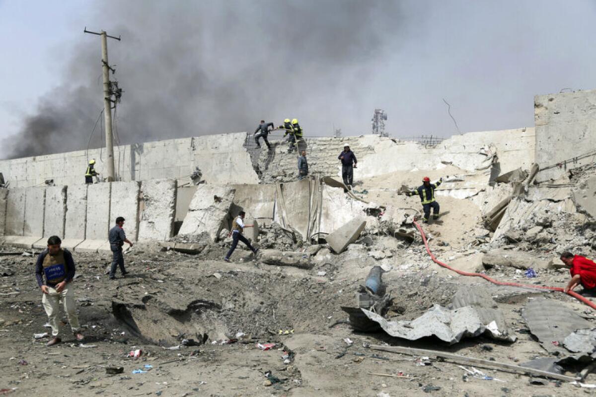 Afghan firefighters work at the site of a suicide bomb attack in Kabul.