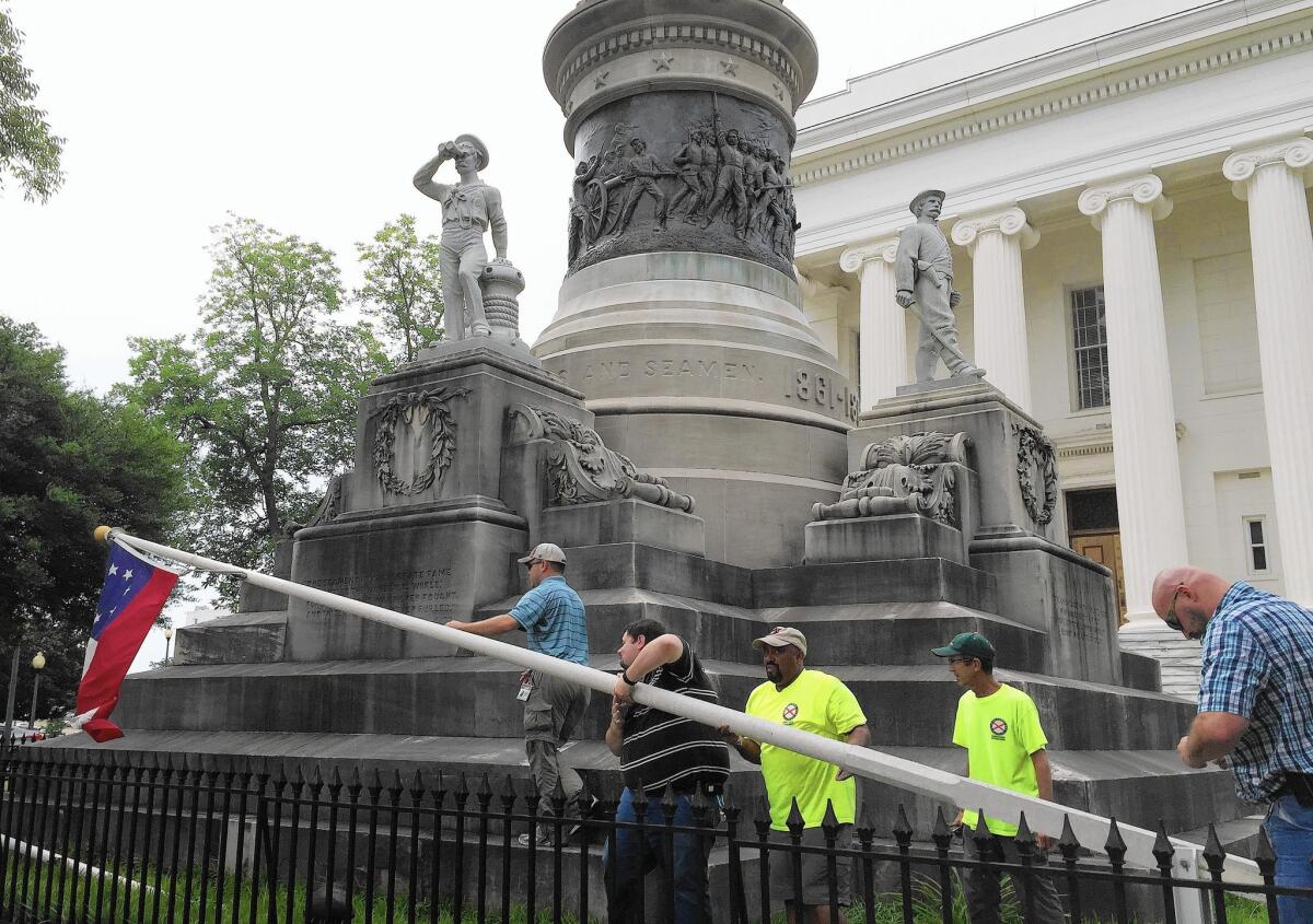 Workers remove a Confederate flag from the grounds of the Alabama state Capitol in Montgomery, on the orders of Gov. Robert J. Bentley.