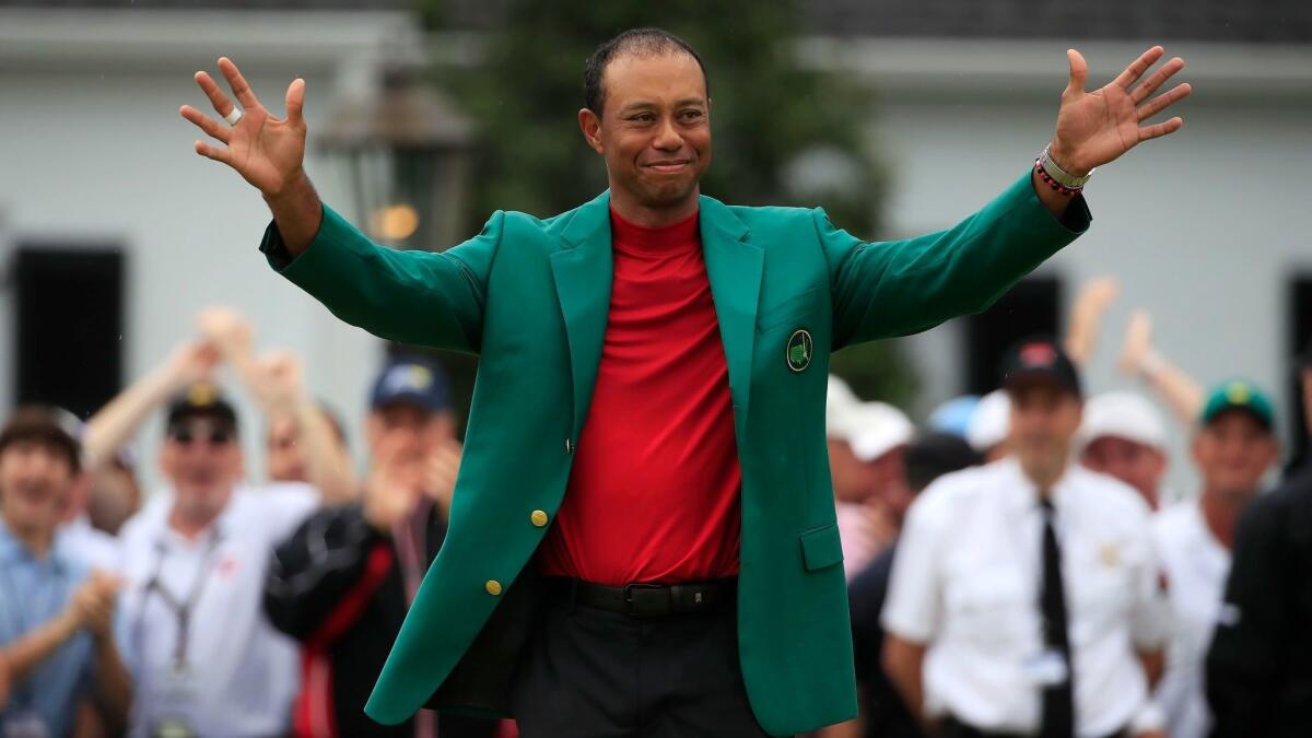 Tiger Woods celebrates after winning the Masters tournament at Augusta (Ga.) National Golf Club on Sunday.