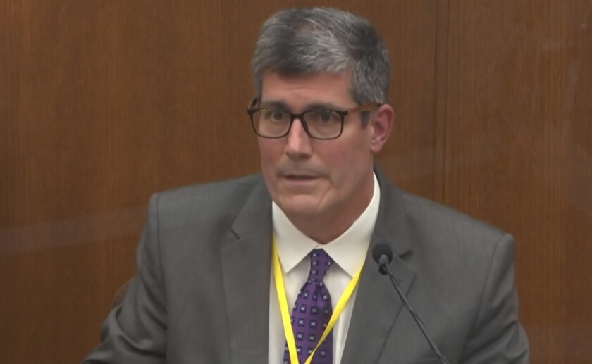 In this image from video, Dr. Andrew Baker, Hennepin County Medical Examiner, testifies as Hennepin County Judge Peter Cahill presides Friday, April 9, 2021, in the trial of former Minneapolis police Officer Derek Chauvin at the Hennepin County Courthouse in Minneapolis, Minn. Chauvin is charged in the May 25, 2020 death of George Floyd. (Court TV via AP, Pool)