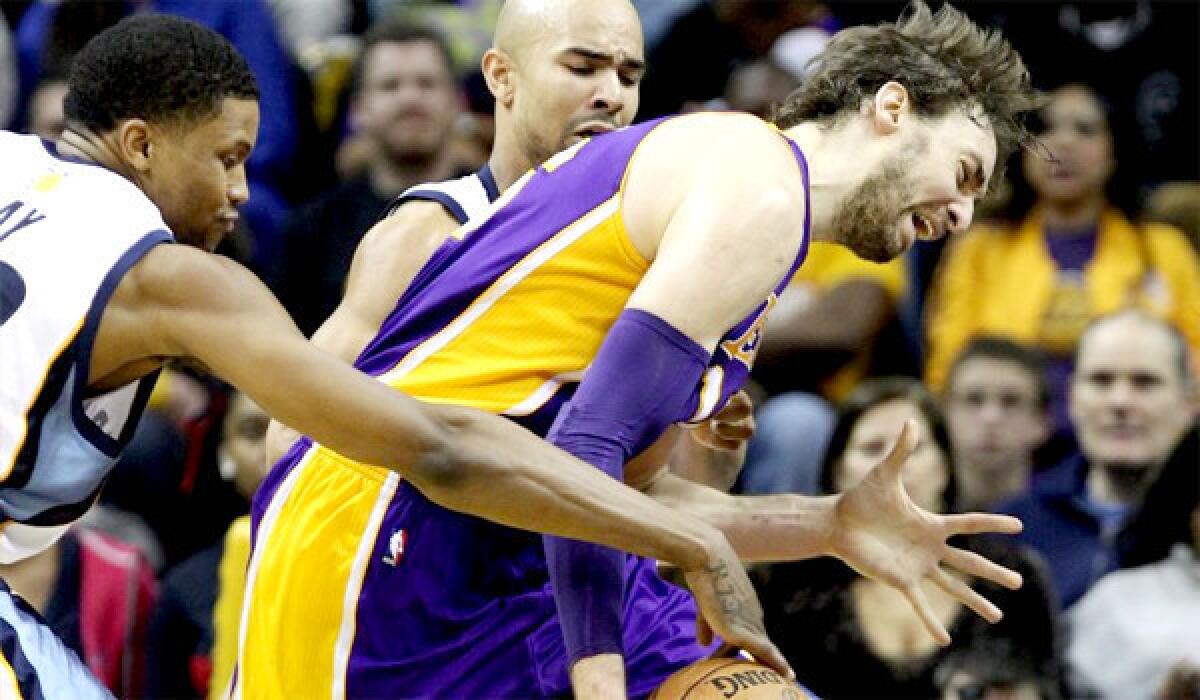 Rudy Gay tries to steal the ball from Pau Gasol with help from Memphis Grizzlies guard Jerryd Bayless.