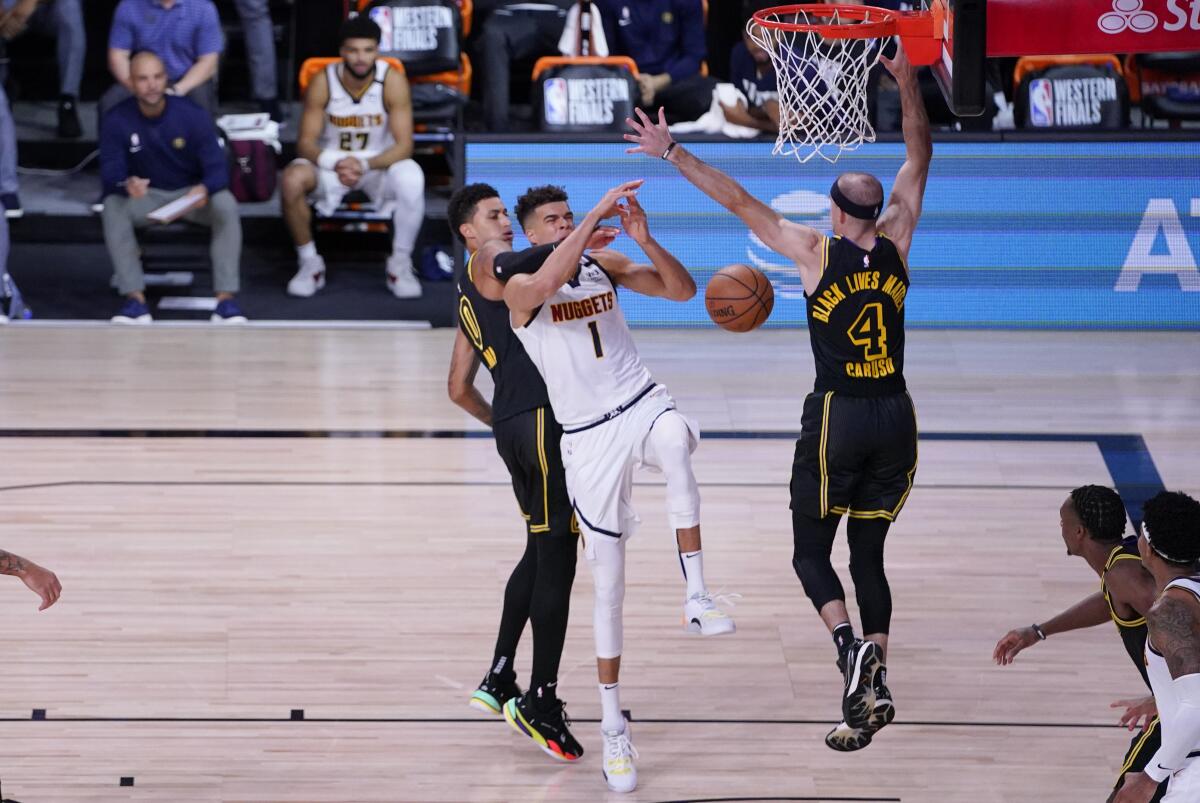 Denver forward Michael Porter Jr. drives to the basket between the Lakers' Kyle Kuzma and Alex Caruso during Game 2.