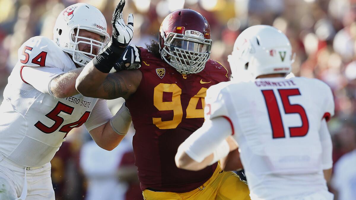 USC defensive end Leonard Williams pressures Fresno State quarterback Brandon Connette, right, during the Trojans' 52-13 win in August. Williams might be a good fit with the Oakland Raiders, who will have a high draft pick in the spring.