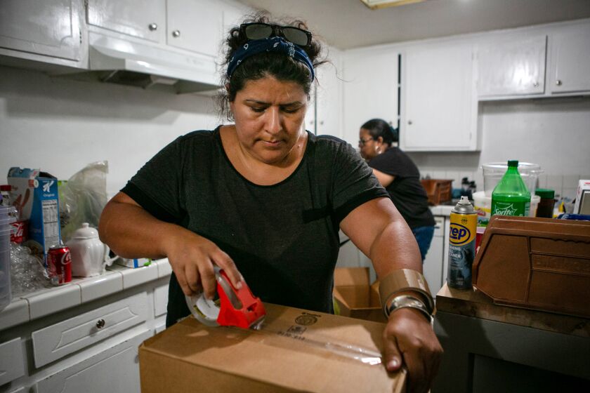 Luz Puebla packs up the kitchen for her families move from Los Angeles to rural Huron, CA