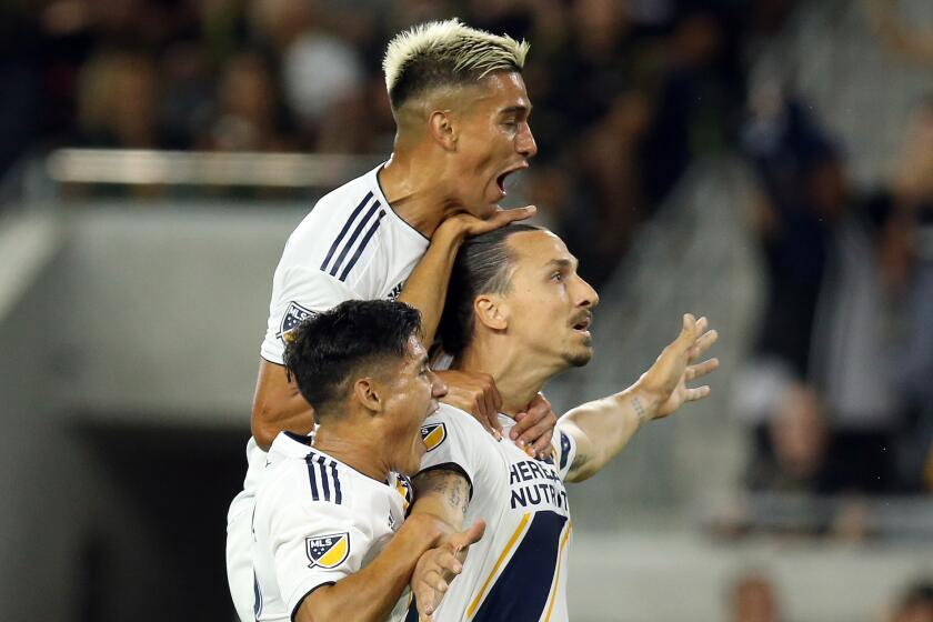 LOS ANGELES, CA -- AUGUST 25, 2019: Galaxy forward Zlatan Ibrahimovic (right) celebrates with teammates Favio Alvarez (top) and Uriel Antuna after scoring his second goal against Los Angeles Football Club on Sunday at Banc of California Stadium. (Myung J. Chun / Los Angeles Times)
