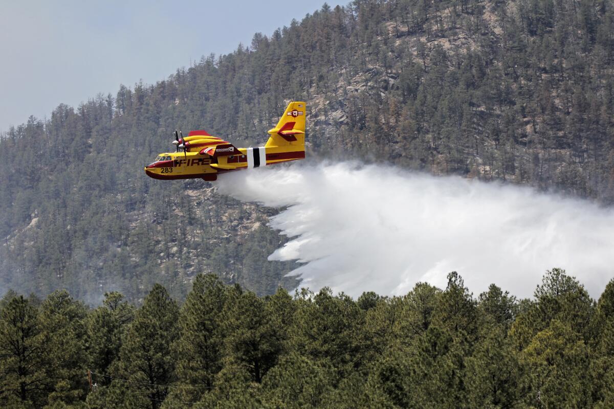 An aircraft known as a "super scooper" battles wildfires in New Mexico.