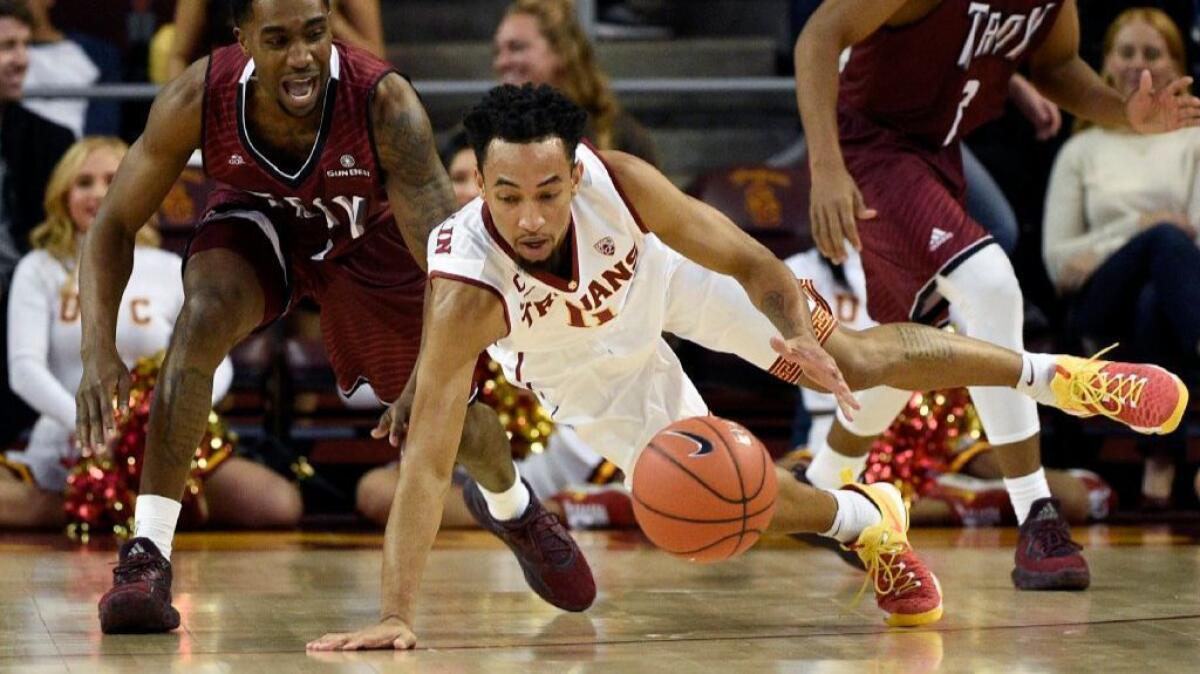 USC guard Jordan McLaughlin dives for the ball against Troy guard Daniel Peace during the first half of a game on Dec. 17.