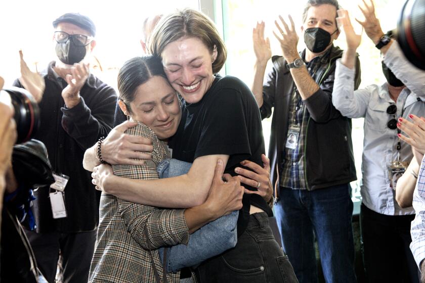 El Segundo, CA - May 02: Los Angeles Times photojournalist Christina House hugs former L.A. Times videographer Claire Collins after winning the Pulitzer Prize for feature photographer at the Times' office in El Segundo, CA. (Keith Bedford / Los Angeles Times)