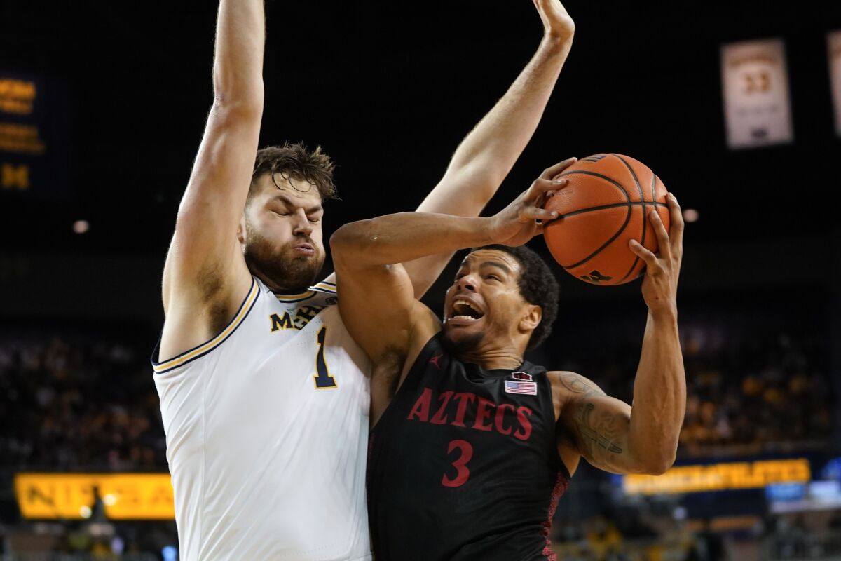 San Diego State's Matt Bradley drives on Michigan center Hunter Dickinson in the first half of Saturday's game.