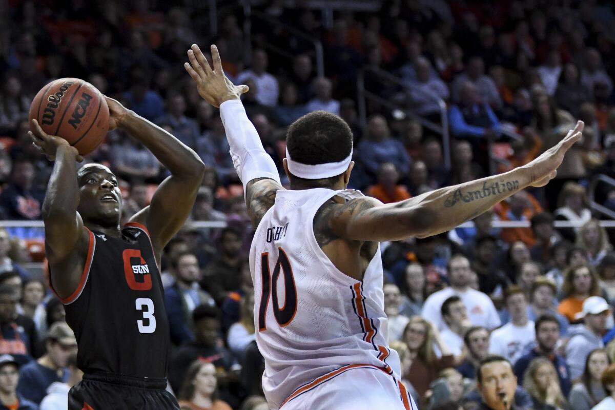 Auburn's Samir Doughty defends a shot by Cal State Northridge's Terrell Gomez on Friday night.