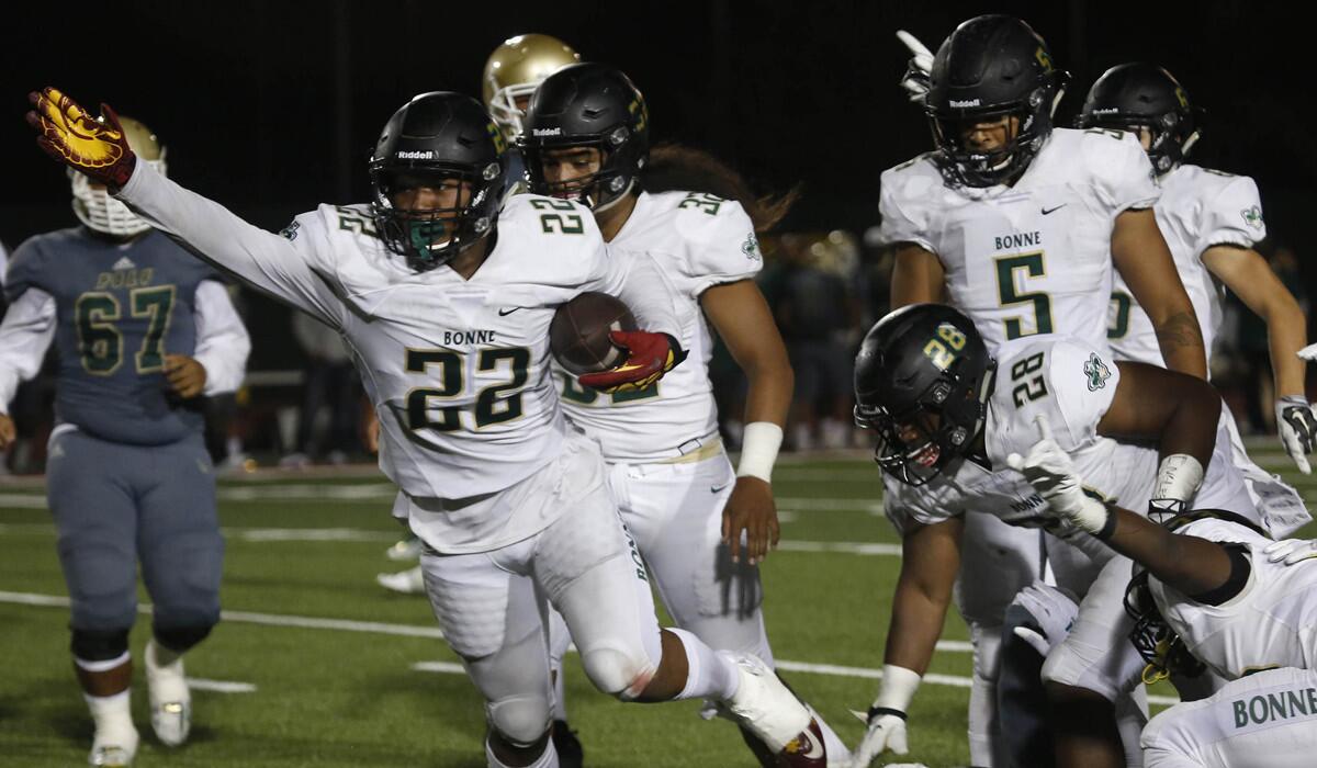 Narbonne linebacker Raymond Scott (22) recovers a fumble in the third quarter against Long Beach Poly High School on Sept. 2.