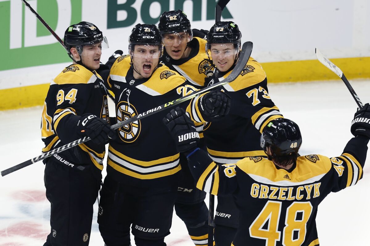 Boston Bruins' Garnet Hathaway (21) celebrates his goal with teammates during the second period of an NHL hockey game against the Tampa Bay Lightning, Saturday, March 25, 2023, in Boston. (AP Photo/Michael Dwyer)