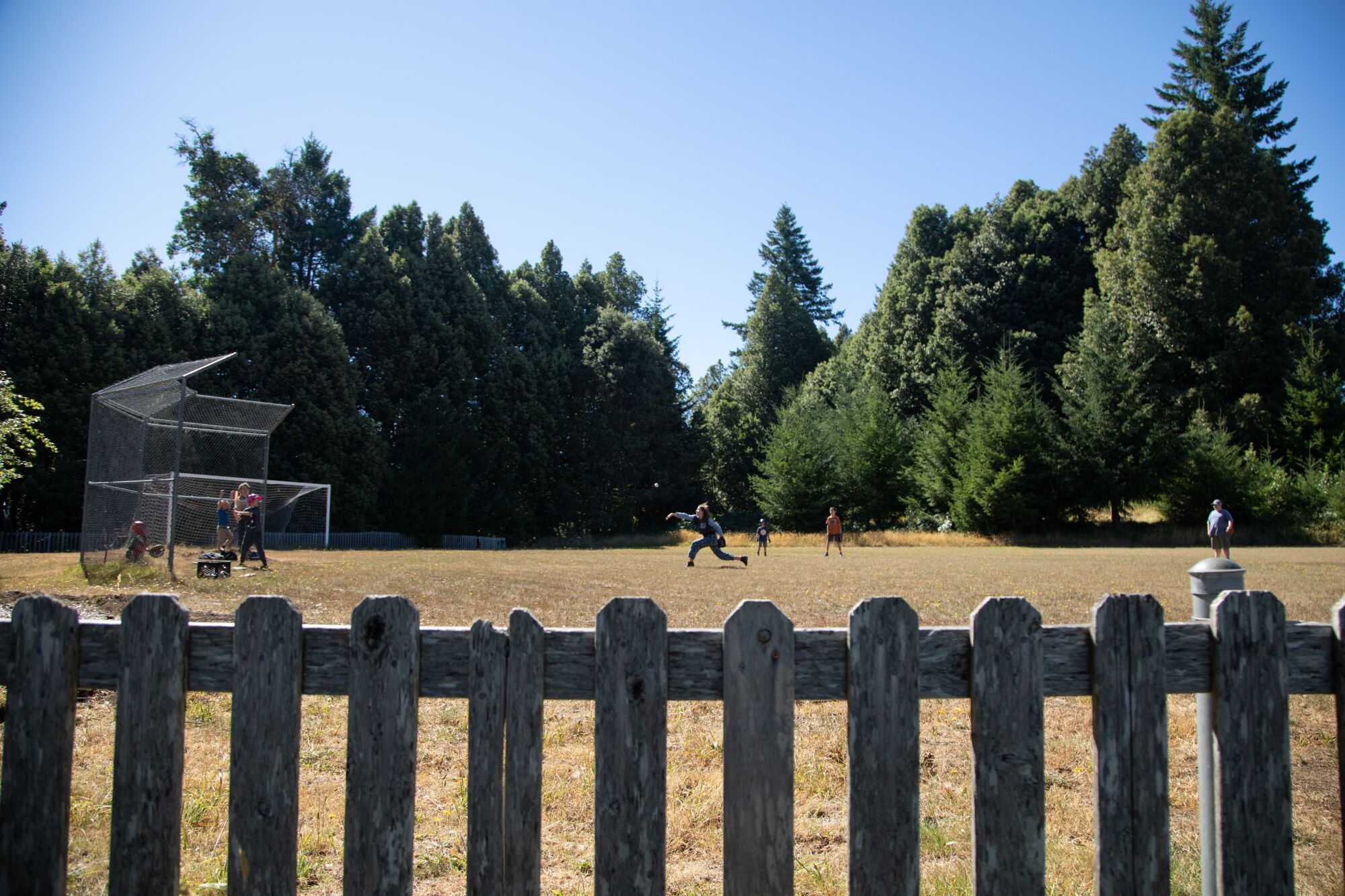 Students play baseball during a school break.
