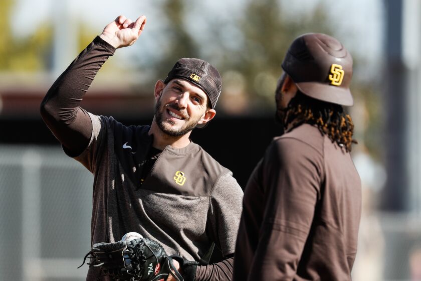 Peoria, AZ - February 19: Padres catchers Austin Nola (26) and Luis Campusano (12) chat during a spring training practice at the Peoria Sports Complex on Sunday, Feb. 19, 2023 in Peoria, AZ. (Meg McLaughlin / The San Diego Union-Tribune)