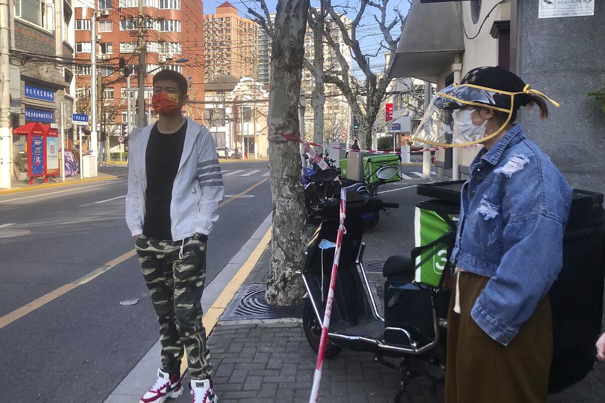 Residents standing on a Shanghai street