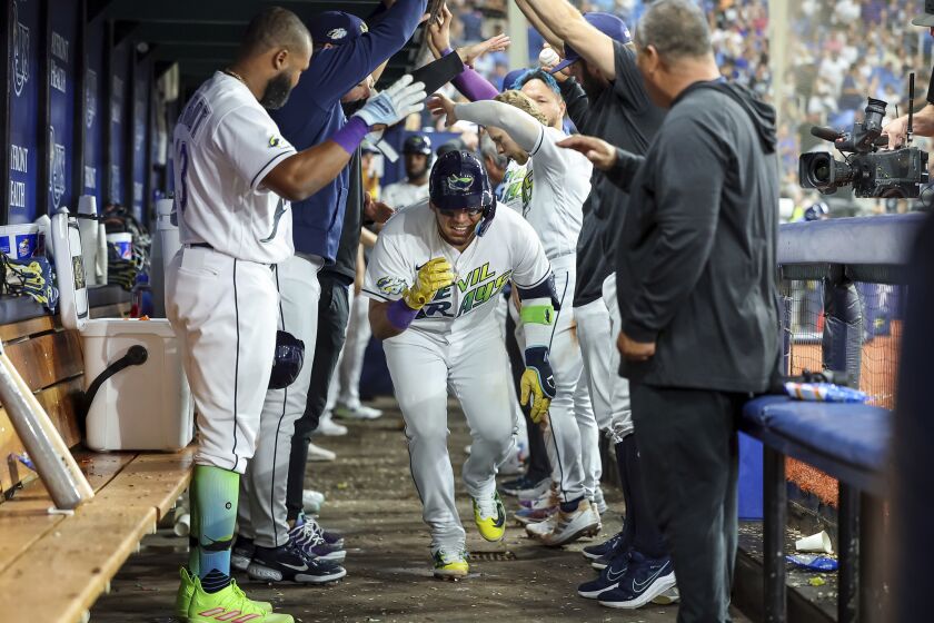 Tampa Bay Rays' Isaac Paredes is congratulated after his home run against the Texas Rangers during the sixth inning of a baseball game Friday, June 9, 2023, in St. Petersburg, Fla. (AP Photo/Mike Carlson)