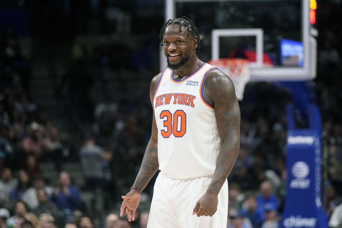 New York Knicks forward Julius Randle (30) smiles as he stands on the floor during the second half of an NBA basketball game against the Dallas Mavericks in Dallas, Wednesday, March 9, 2022. The Knicks won 107-77. (AP Photo/LM Otero)