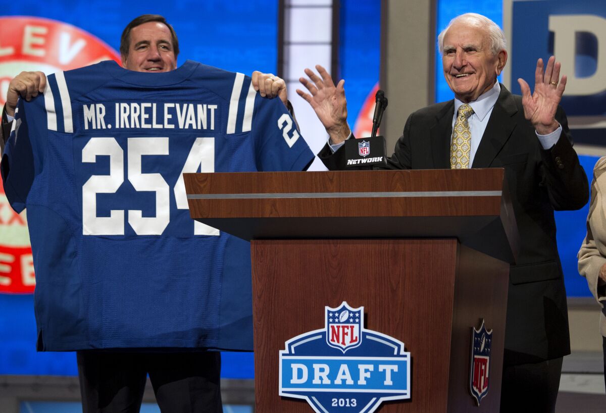 FILE - In this Saturday, April 27, 2013, file photo, former NFL football receiver Paul Salata, right, announces the 254th overall pick of the NFL Draft at Radio City Music Hall in New York. Salata, who created the Mr. Irrelevant Award that honors the last selection of the NFL draft, after playing football at Southern California and in the NFL and Canadian Football League, died Saturday, Oct. 16, 2021. He was 94. (AP Photo/Craig Ruttle, File)