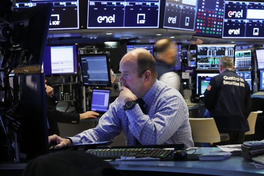 Trader Peter Mancuso prepares for the day's trading, on the floor of the New York Stock Exchange, Thursday, March 5, 2020. (AP Photo/Richard Drew)