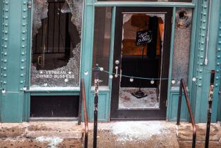 A bar in ruins, full of broken glass, after a night of protests that culminated in a shooting.