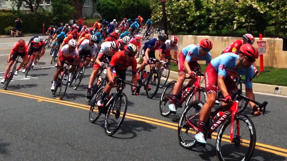 Men cyclists turn from Angeles Crest Highway onto Green Lane during the 2019 Amgen Tour of California Stage 7 from Santa Clarita through the Angeles National Forest into La Cañada Flintridge Saturday afternoon on the way to the finish line in Pasadena.
