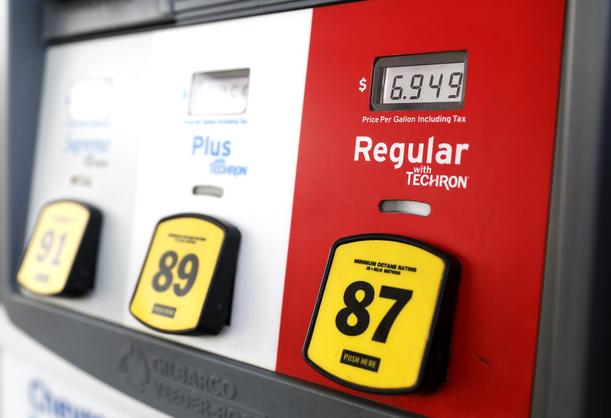 A gas pump shows $6.949 for regular.