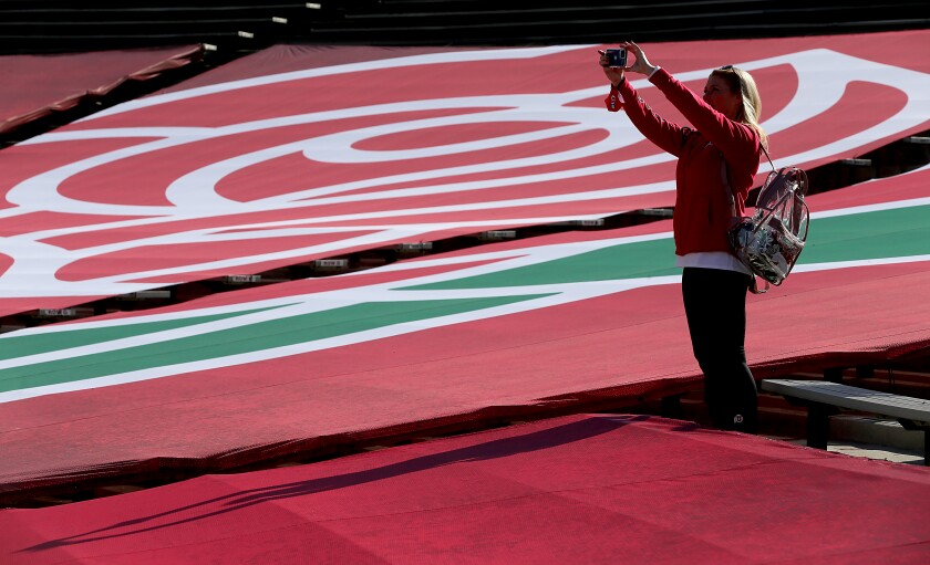 A Utah fan takes a selfie in a covered section of the end zone at the Rose Bowl before Saturday's game.