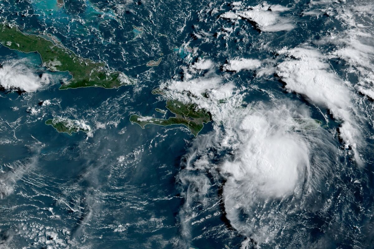This satellite image provided by the National Oceanic and Atmospheric Administration (NOAA) shows a Tropical Storm Fred in the Caribbean as it passes south of Puerto Rico and the Dominican Republic at 8am EST, Wednesday, Aug. 11, 2021. (NOAA/NESDIS/STAR GOES via AP)