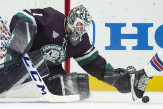 Anaheim Ducks goaltender Lukas Dostal (1) reaches for the puck during the first period.