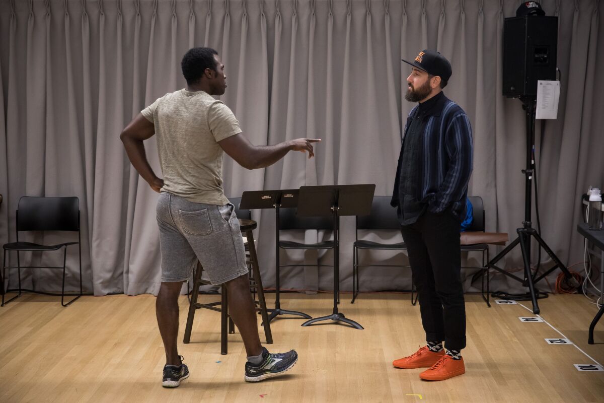 Actor Joshua Henry, left, talks with Ross Golan, writer of "The Wrong Man," in August.