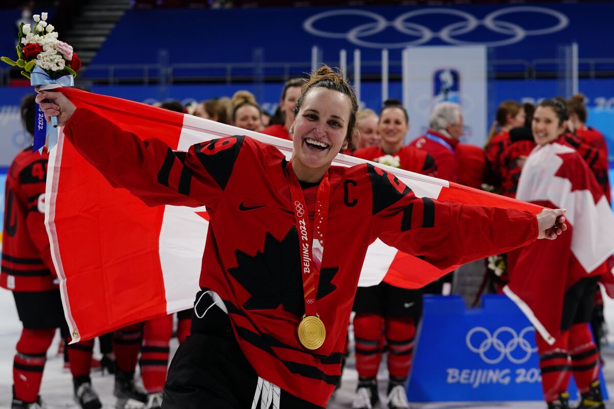 Canada's Marie-Philip Poulin (29) celebrates with her gold medal after the women's gold medal hockey game at the 2022 Winter Olympics, Thursday, Feb. 17, 2022, in Beijing. (AP Photo/Matt Slocum)