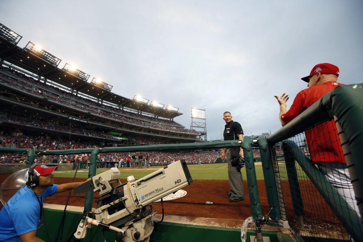 Home plate umpire Jim Wolf talks with Nationals Manager Matt Williams after some of the lights went out and play was halted during the fourth inning of a game against the Dodgers on Friday night in Washington.