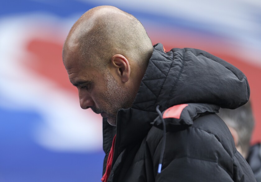 Manchester City's head coach Pep Guardiola walks from the pitch at halftime of the English Premier League soccer match between Crystal Palace and Manchester City at Selhurst Park in London, England, Saturday, May 1, 2021. (AP Photo/Steve Paston/Pool)