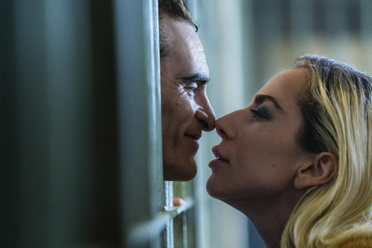 A man peering out through jail cell bars and a blond woman appear about to kiss