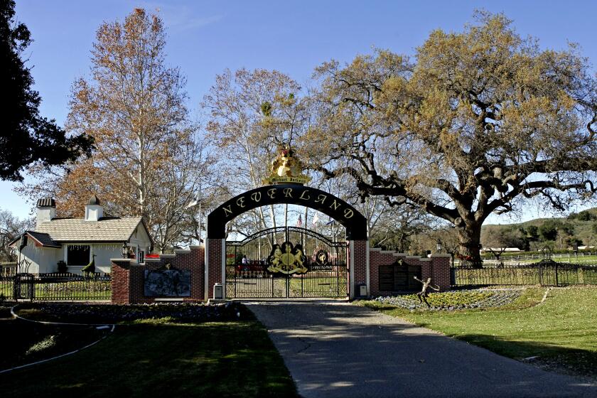 FILE - This Dec. 17, 2004 file photo shows the rear entrance to pop star Michael Jackson's Neverland Ranch home in Santa Ynez, Calif, where several hundred children were invited to the estate for a holiday celebration. In 2014, Jackson's playtime palace sits empty now. The backyard circus and laughter of children are long gone, but the house and its fanciful memories live on. (AP Photo/Mark J. Terrill, file)