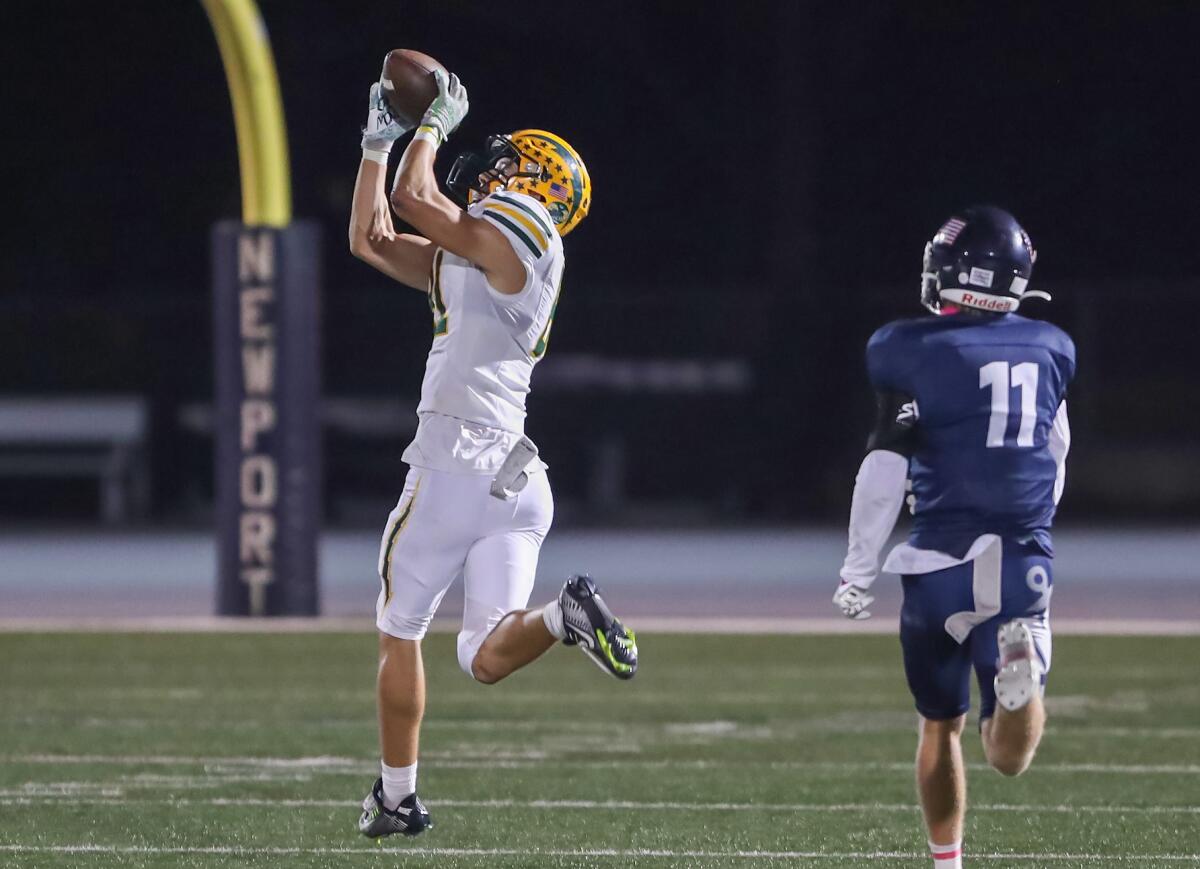 Edison receiver Mason York catches a pass in the open field for a touchdown against Newport Harbor on Friday.