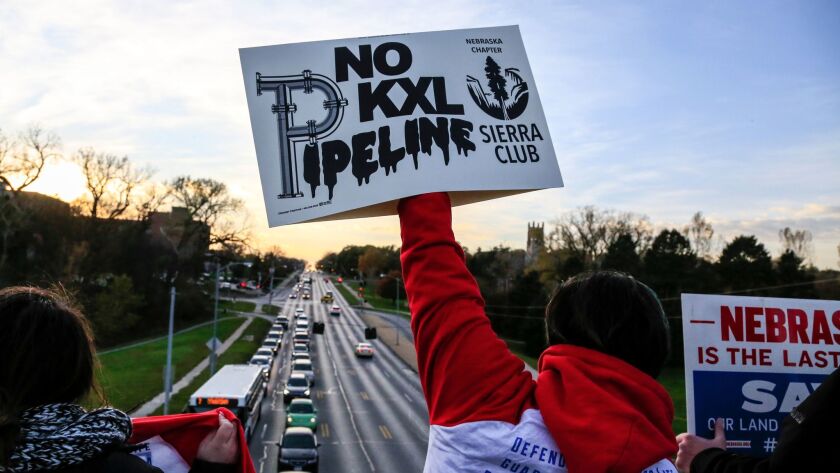 Opponents of the Keystone XL pipeline demonstrate on the Dodge Street pedestrian bridge during rush hour in Omaha on Nov. 1.