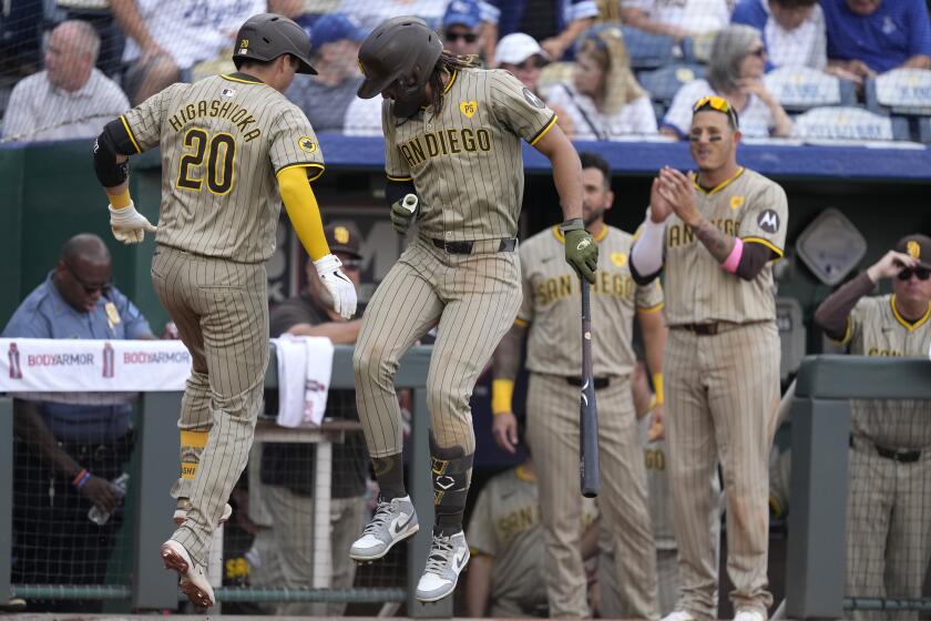 San Diego Padres' Kyle Higashioka (20) celebrates with Fernando Tatis Jr. after hitting a solo home run during the ninth inning of a baseball game against the Kansas City Royals Saturday, June 1, 2024, in Kansas City, Mo. The Padres won 7-3. (AP Photo/Charlie Riedel)