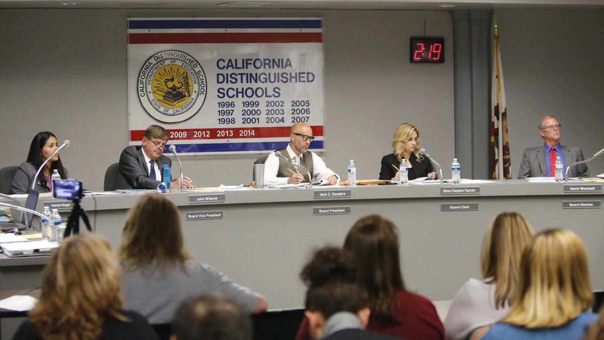 Ocean View School District board members Patricia Singer, John Briscoe, Jack Souders, Gina Clayton-Tarvin and Norm Westwell, from left, listen to public comments during their meeting Tuesday night.