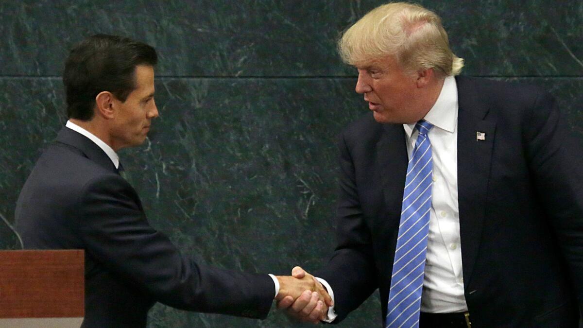 Mexico's President Enrique Peña Nieto, shakes hands with then-Republican presidential nominee Donald Trump after a joint statement at Los Piños, the presidential official residence in Mexico City, on Aug. 31, 2016.