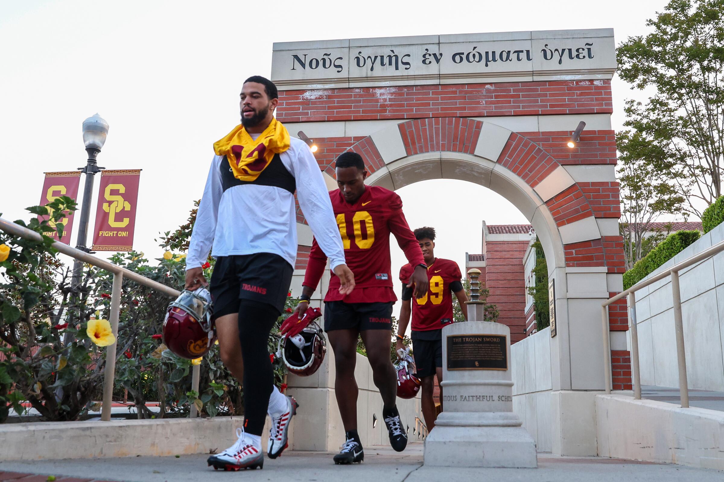 USC quarterback Caleb Williams and his teammates walk to the field for preseason practice.